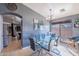 Elegant dining area featuring a modern glass table, stylish chairs, and natural light at 13547 W Peck Dr, Litchfield Park, AZ 85340