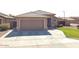 Charming single-story home with a well-maintained front yard and a spacious two-car garage at 13547 W Peck Dr, Litchfield Park, AZ 85340