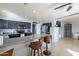 Open-concept kitchen with stainless steel appliances, breakfast bar, and tile flooring at 13547 W Peck Dr, Litchfield Park, AZ 85340