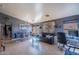 Stylish living and dining area featuring modern furniture, tile flooring, and ample natural light at 13547 W Peck Dr, Litchfield Park, AZ 85340