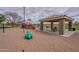 Playground area with play structures, slides, and picnic shelter for outdoor fun and recreation at 13547 W Peck Dr, Litchfield Park, AZ 85340