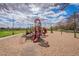 Playground area with play structures, slides, and soft sand surfacing for outdoor fun and recreation at 13547 W Peck Dr, Litchfield Park, AZ 85340