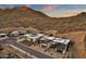 An aerial view of modern desert homes nestled against a dramatic mountain backdrop at 14715 N Adero Canyon Dr, Fountain Hills, AZ 85268
