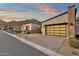 Modern home with a stylish garage door and desert landscaping against a mountain backdrop at 14715 N Adero Canyon Dr, Fountain Hills, AZ 85268