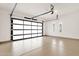 Bright and spacious garage featuring an epoxy floor and a modern glass door at 14715 N Adero Canyon Dr, Fountain Hills, AZ 85268