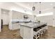 Spacious kitchen featuring a large island with seating, custom cabinets, and stainless steel appliances at 14715 N Adero Canyon Dr, Fountain Hills, AZ 85268