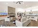 Bright, open-concept living area with tile floors, a modern fireplace, and sleek white furniture at 14715 N Adero Canyon Dr, Fountain Hills, AZ 85268