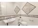 Contemporary powder room featuring pedestal sink, decorative diamond patterned wall, and modern fixtures at 14715 N Adero Canyon Dr, Fountain Hills, AZ 85268
