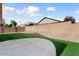 Backyard featuring artificial grass and desert landscaping along a block fence at 14994 W Charter Oak Rd, Surprise, AZ 85379