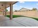 An open backyard features a patio and artificial grass at 14994 W Charter Oak Rd, Surprise, AZ 85379