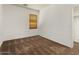 Cozy bedroom with warm-toned carpet, a small window, and baseboard trim at 14994 W Charter Oak Rd, Surprise, AZ 85379