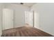 Bedroom with neutral walls and carpet, featuring two open doorways at 14994 W Charter Oak Rd, Surprise, AZ 85379