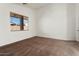 Empty bedroom with neutral walls, carpeted floors, a window with blinds, and a closet at 14994 W Charter Oak Rd, Surprise, AZ 85379