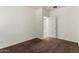 Empty bedroom with neutral walls, carpet, and a door ajar at 14994 W Charter Oak Rd, Surprise, AZ 85379