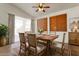 Traditional dining room showcasing a wood table, six upholstered chairs, and ample natural light at 14994 W Charter Oak Rd, Surprise, AZ 85379