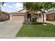 Inviting single-story home featuring a well-maintained lawn and a convenient two-car garage at 14994 W Charter Oak Rd, Surprise, AZ 85379
