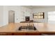 Kitchen view highlighting the island sink and an adjacent fireplace with built in shelves at 14994 W Charter Oak Rd, Surprise, AZ 85379