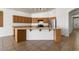 Bright kitchen featuring a large island, stainless steel appliances, and wooden cabinetry at 14994 W Charter Oak Rd, Surprise, AZ 85379