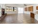 Spacious living area with fireplace, tile flooring, and large windows at 14994 W Charter Oak Rd, Surprise, AZ 85379