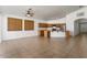 Open concept living space with kitchen island, tile floors, and bright lighting at 14994 W Charter Oak Rd, Surprise, AZ 85379