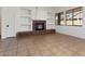 Inviting living room featuring a stone fireplace, built-in shelving, and ample space at 14994 W Charter Oak Rd, Surprise, AZ 85379