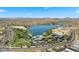 Scenic aerial view of the community showcasing a lake, green spaces, and residential areas against a mountain backdrop at 15720 S 182Nd Ave, Goodyear, AZ 85338