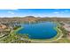 Breathtaking aerial view of the large lake surrounded by lush greenery and homes in the community at 15720 S 182Nd Ave, Goodyear, AZ 85338