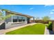 Backyard view that shows outdoor living with artificial turf, desert landscaping, and block fence for privacy at 15720 S 182Nd Ave, Goodyear, AZ 85338