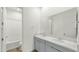 Bright bathroom with double sinks, a large mirror, and a shower-tub combination in a neutral color palette at 15720 S 182Nd Ave, Goodyear, AZ 85338
