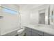 Clean, well-lit bathroom with a modern vanity, a large mirror, and a shower-tub combination at 15720 S 182Nd Ave, Goodyear, AZ 85338