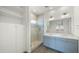 Modern bathroom with double vanity, glass-enclosed shower, and elegant fixtures, offering a spa-like experience at 15720 S 182Nd Ave, Goodyear, AZ 85338