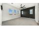 Spacious carpeted bedroom with a ceiling fan and ample natural light from numerous windows at 15720 S 182Nd Ave, Goodyear, AZ 85338