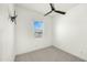 Spare bedroom with carpeted floor, ceiling fan and window at 15720 S 182Nd Ave, Goodyear, AZ 85338