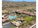 Elevated view showcasing the community clubhouse, pool, seating, and well manicured landscape, perfect for relaxation at 15720 S 182Nd Ave, Goodyear, AZ 85338