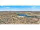 Wide aerial view of the community with diverse housing options, desert landscape, and recreational lake at 15720 S 182Nd Ave, Goodyear, AZ 85338