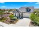 Beautiful single Gathering home with manicured landscaping, a wide driveway, and a charming facade at 15720 S 182Nd Ave, Goodyear, AZ 85338