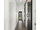 Long hallway with striking barn door and view to the front door at 15720 S 182Nd Ave, Goodyear, AZ 85338