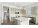 Well-lit kitchen featuring a center island, stainless steel appliances, modern fixtures, and beautiful backsplash at 15720 S 182Nd Ave, Goodyear, AZ 85338