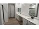 Bathroom features dual sinks, quartz counters, and a modern glass shower at 15782 W Cheryl Dr, Waddell, AZ 85355