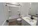 Full bathroom with a shower-tub combo, white vanity, and black fixtures at 15782 W Cheryl Dr, Waddell, AZ 85355