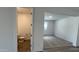 A half bath is visible off of a room with carpet and tile floors at 15782 W Cheryl Dr, Waddell, AZ 85355