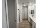 Bright bathroom showcasing a glass shower, white cabinets, and dual sinks at 15782 W Cheryl Dr, Waddell, AZ 85355