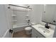 Bathroom featuring white tile, a neutral vanity, a tub-shower, and modern black fixtures for a sleek aesthetic at 15782 W Cheryl Dr, Waddell, AZ 85355