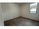 A view of an empty bedroom with neutral carpet and a window with blinds at 15782 W Cheryl Dr, Waddell, AZ 85355