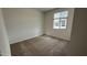 Empty bedroom with neutral carpet and a window with blinds at 15782 W Cheryl Dr, Waddell, AZ 85355
