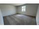 This carpeted bedroom boasts bright natural light and neutral walls at 15782 W Cheryl Dr, Waddell, AZ 85355