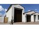Side view of a home showcasing the stucco exterior and a large three-car garage at 15782 W Cheryl Dr, Waddell, AZ 85355