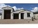 Charming single-story home featuring a three-car garage, neutral stucco exterior, and desert landscaping for modern appeal at 15782 W Cheryl Dr, Waddell, AZ 85355