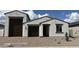 Charming single-story home with a stucco exterior, brown accents, and a three-car garage at 15782 W Cheryl Dr, Waddell, AZ 85355