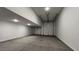 Large garage featuring two overhead doors and recessed lighting at 15782 W Cheryl Dr, Waddell, AZ 85355